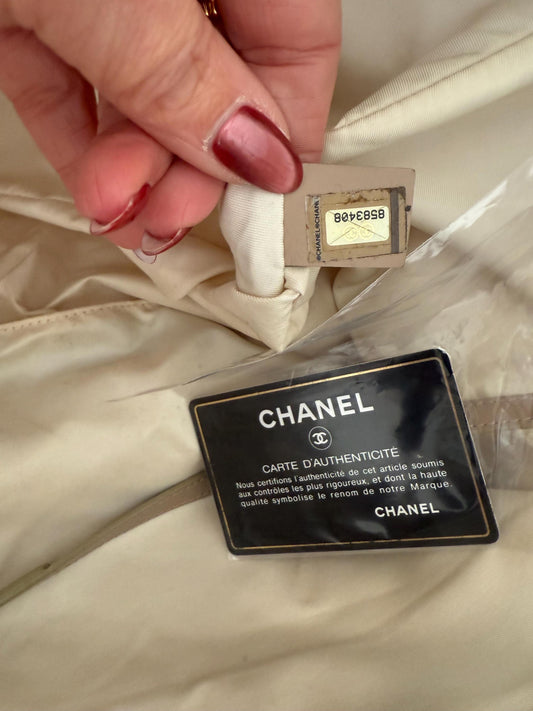 AUTHENTIC Chanel Travel Line tote bag in a blush pink nylon canvas with beige leather trim and straps