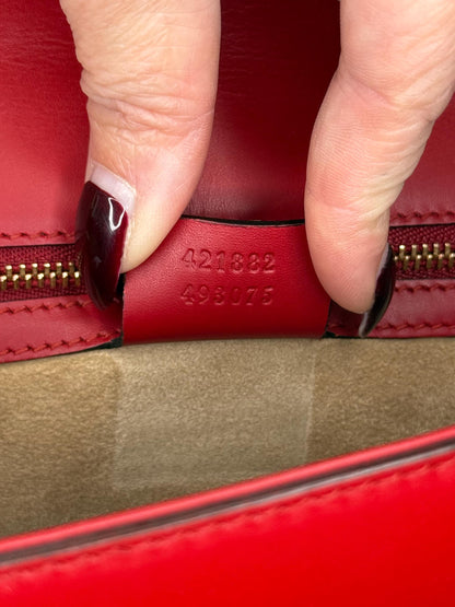 AUTHENTIC Gucci Red Leather Sylvie Sholuder Bag with gold-tone chain and buckle hardware.
