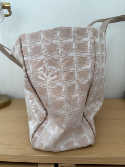 AUTHENTIC Chanel Travel Line tote bag in a blush pink nylon canvas with beige leather trim and straps