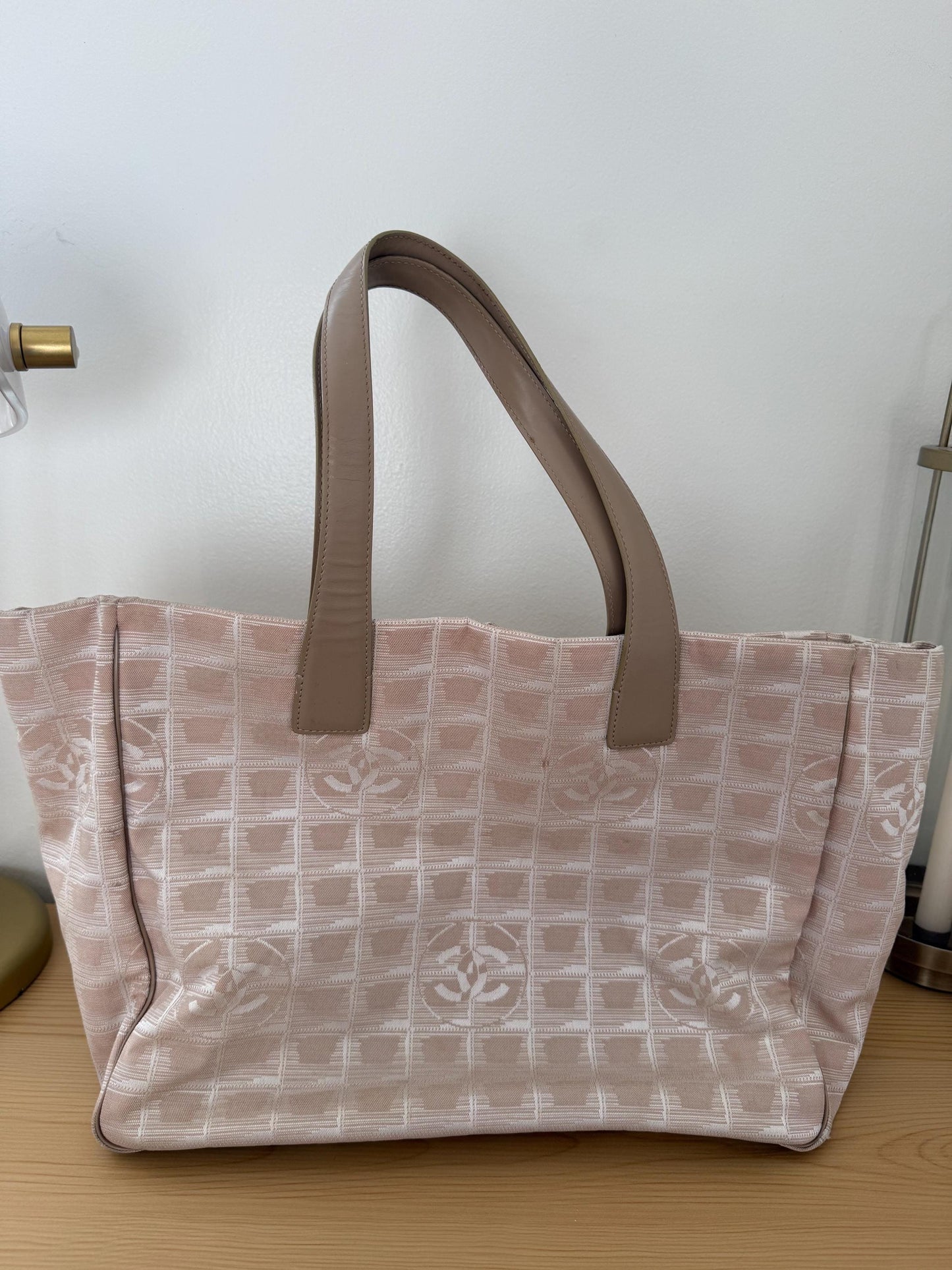 AUTHENTIC Chanel Travel Line tote bag in a blush pink nylon canvas with beige leather trim and straps