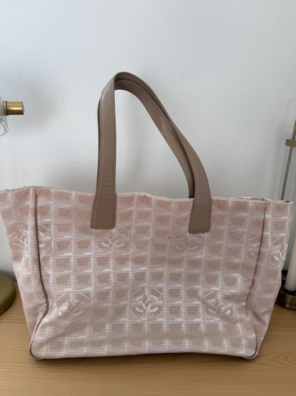 AUTHENTIC Chanel Travel Line tote bag in a blush pink nylon canvas with beige leather trim and straps
