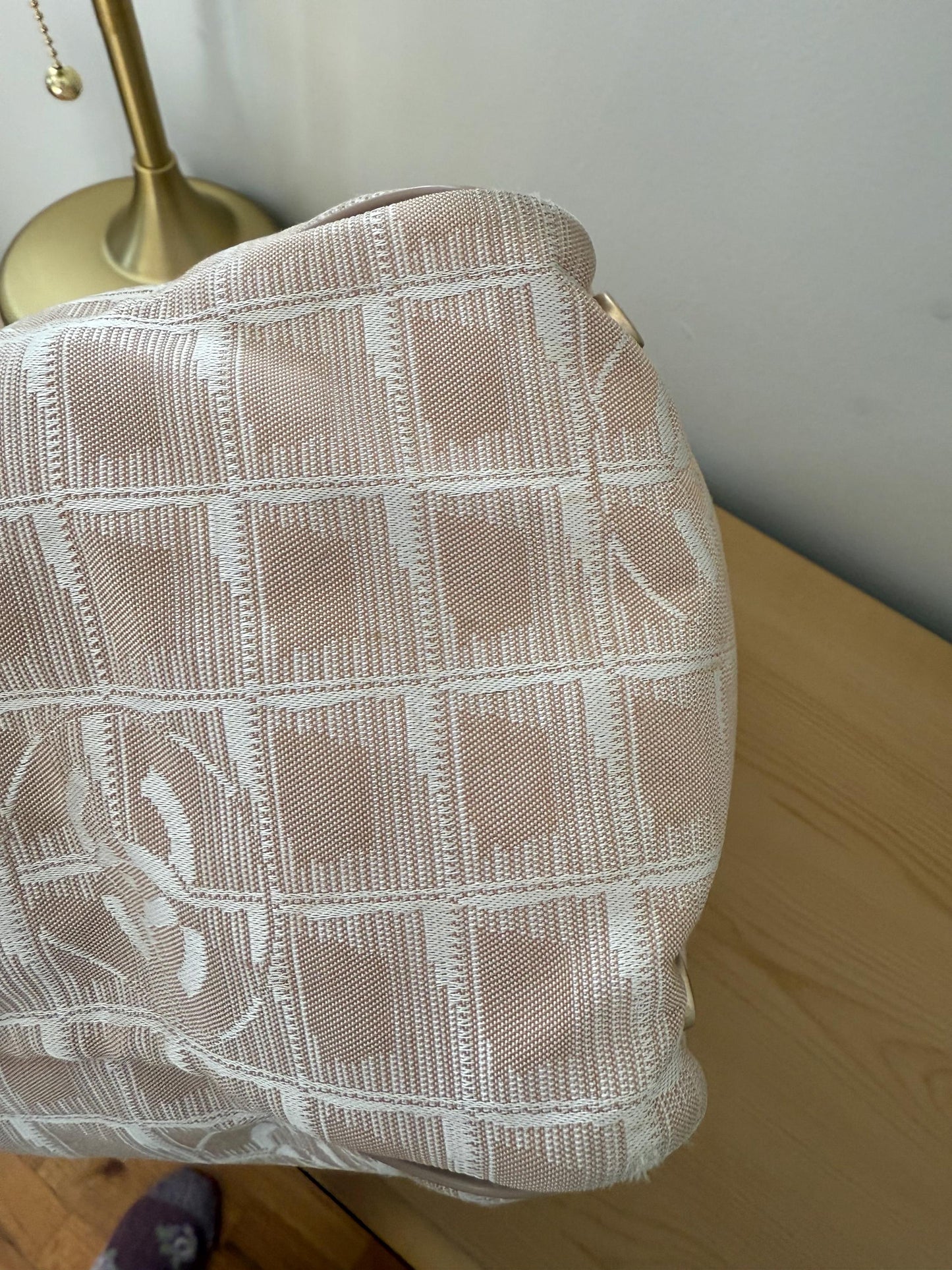 AUTHENTIC Chanel Travel Line tote bag in a blush pink nylon canvas with beige leather trim and straps