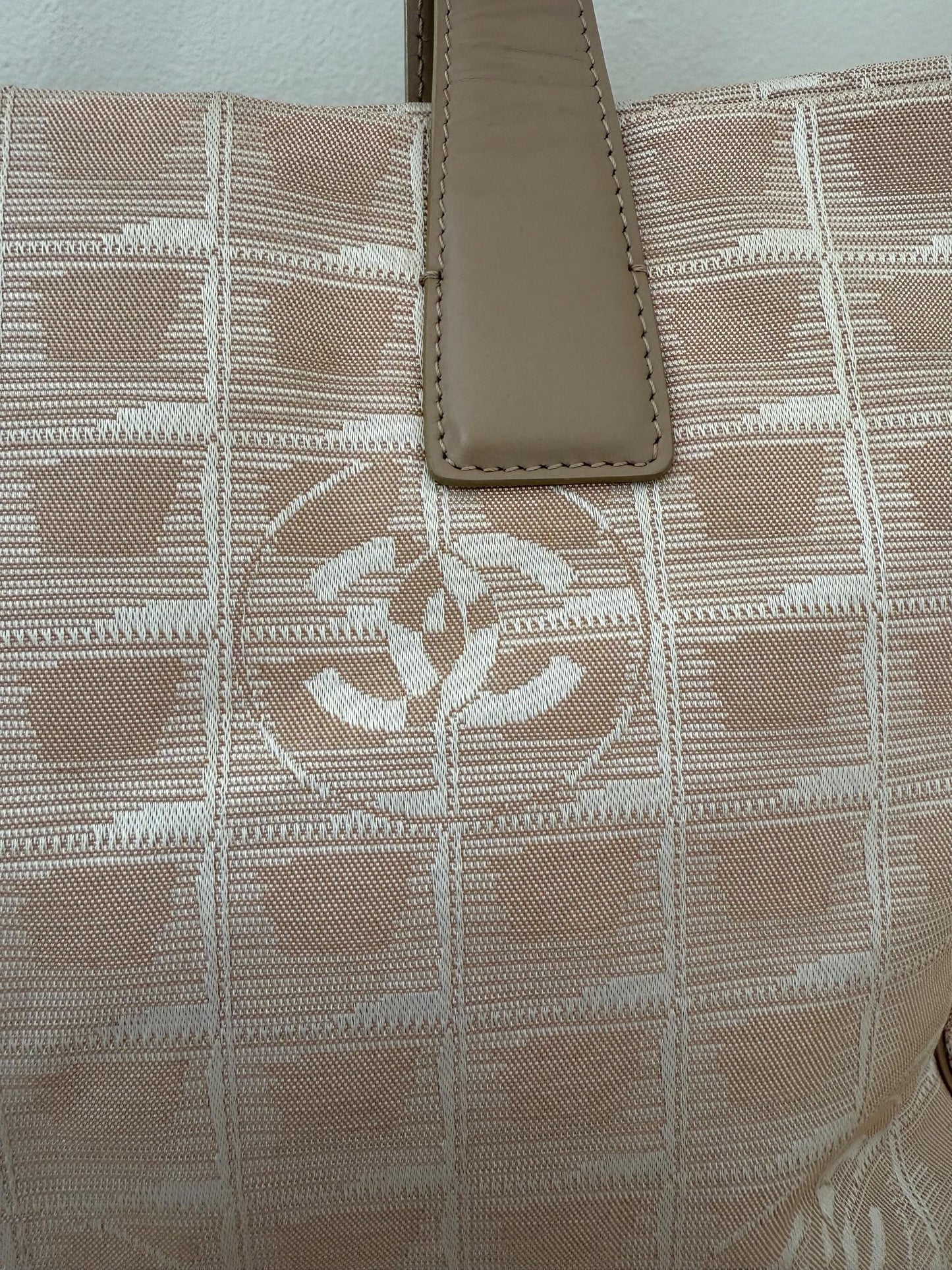 AUTHENTIC Chanel Travel Line tote bag in a blush pink nylon canvas with beige leather trim and straps