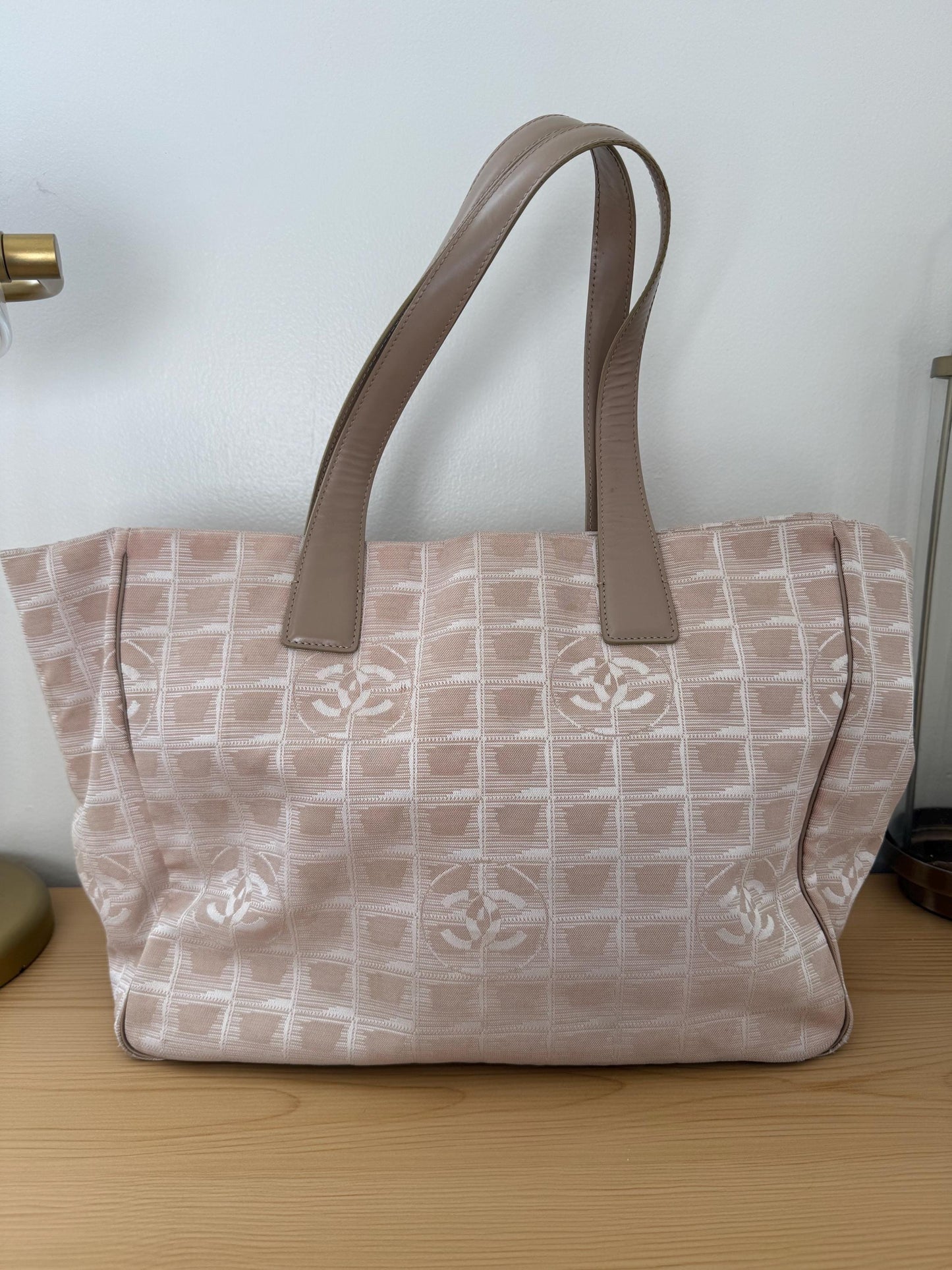 AUTHENTIC Chanel Travel Line tote bag in a blush pink nylon canvas with beige leather trim and straps
