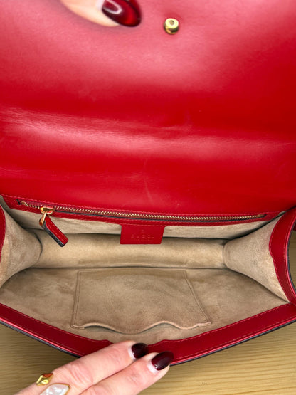 AUTHENTIC Gucci Red Leather Sylvie Sholuder Bag with gold-tone chain and buckle hardware.